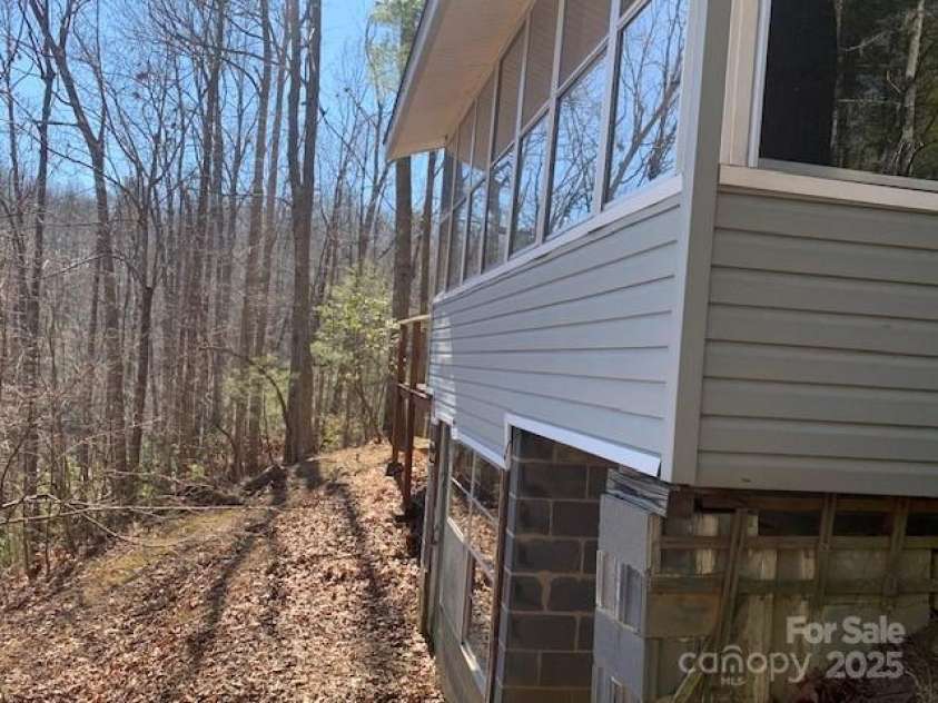 60 LAKEMONT COTTAGE Trail, Flat Rock, NC 28739.  MLS# CAR4233288, YatesRealty ID 1907. REAR, SEE ALL THE GLASS TO THE VIEW.
