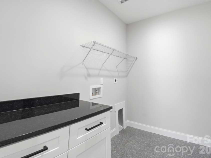 302 Lima Avenue, Charlotte, NC 28208.  MLS# CAR4363412, YatesRealty ID 19070. Downstairs laundry with folding table