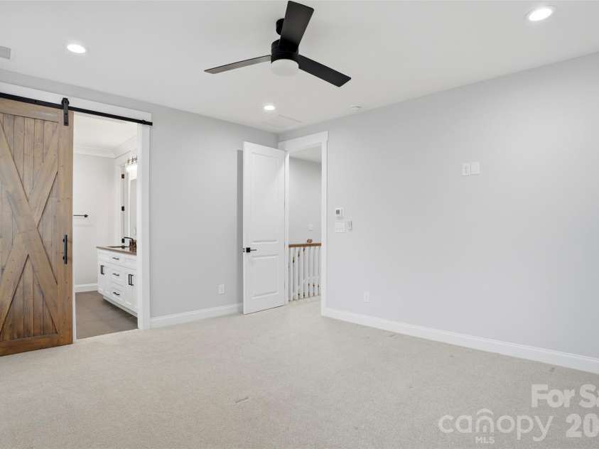 302 Lima Avenue, Charlotte, NC 28208.  MLS# CAR4363412, YatesRealty ID 19070. Stunning barn doors in primary bedroom