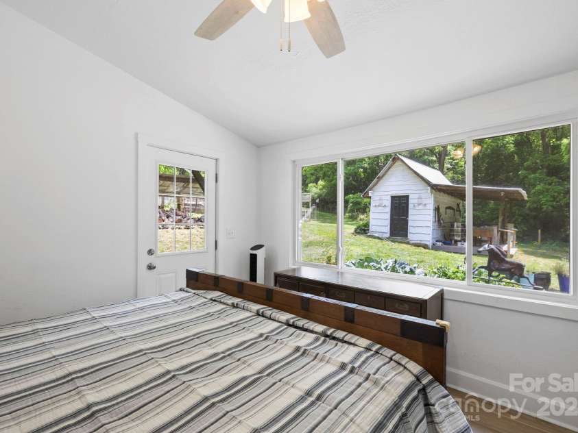 51 HOMEFIRE COVE Cove, Leicester, NC 28748.  MLS# CAR4269158, YatesRealty ID 19075. Rear bedroom looks out to property