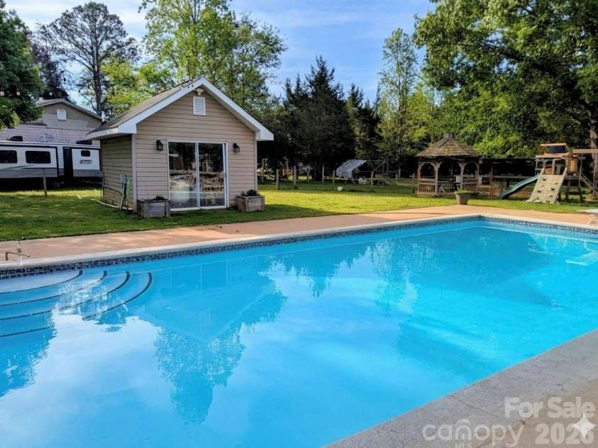 5226 Old Plank Road, Iron Station, NC 28080.  MLS# CAR4365700, YatesRealty ID 19087. Beautiful refreshing pool, little “house” containing pool equipment and a 1/4 bathroom so no dripping water into the house