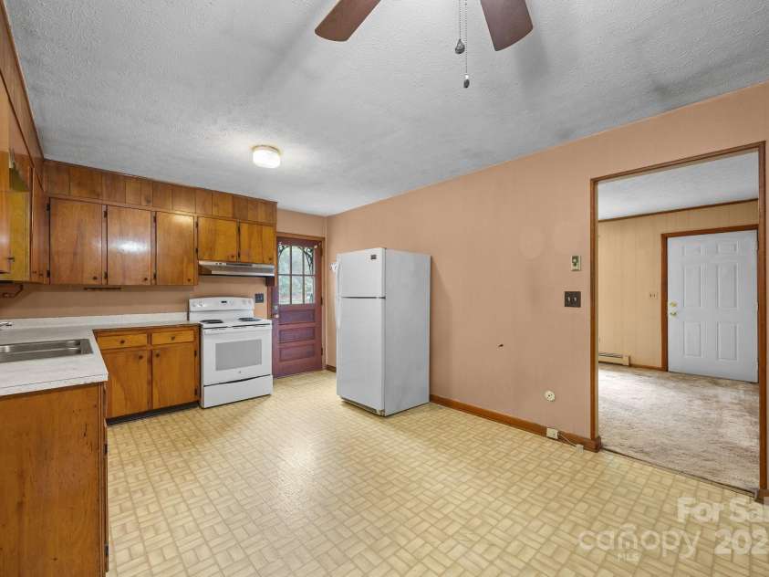 327 Glenwood Drive, Clyde, NC 28721.  MLS# CAR4269570, YatesRealty ID 19089. Kitchen with Side Entry Door