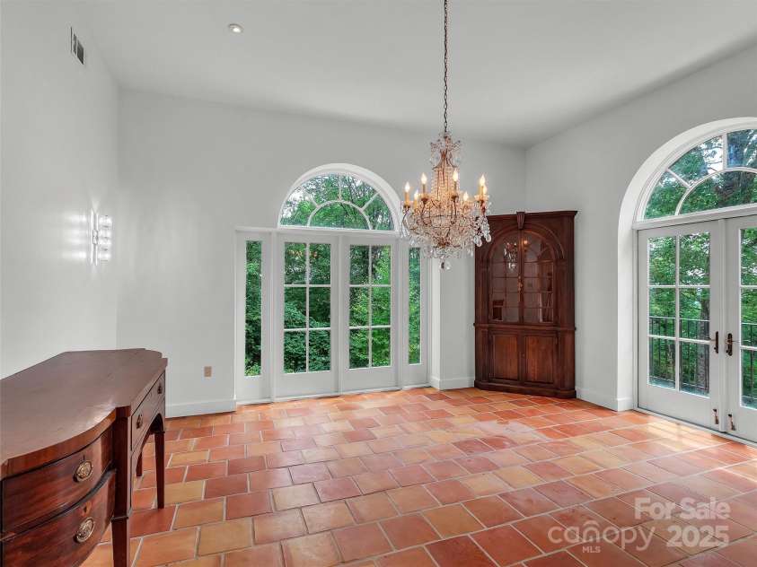 2222 Greenspire Drive, Sylva, NC 28779.  MLS# CAR4159278, YatesRealty ID 1909. Dining Room with antique cabinetry, buffet, and chandelier.