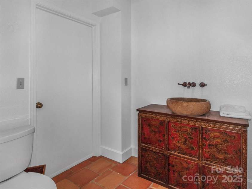 2222 Greenspire Drive, Sylva, NC 28779.  MLS# CAR4159278, YatesRealty ID 1909. Half Bath-Main Level with antique vanity.