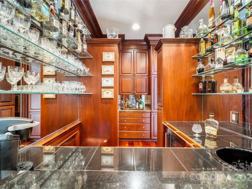 2665 Rolling Hills Drive, Monroe, NC 28110.  MLS# CAR4296531, YatesRealty ID 191. Centrally showcased wet bar with ample storage.