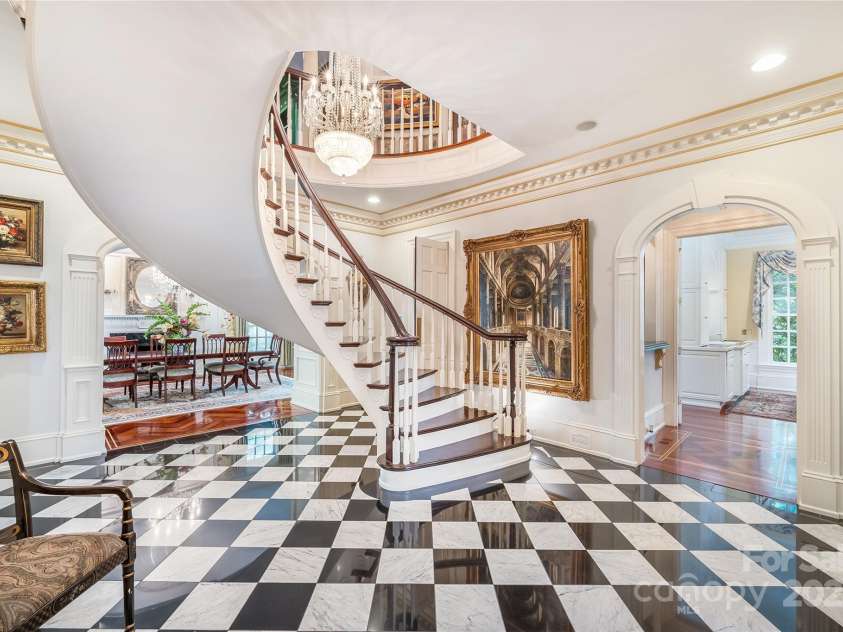 2665 Rolling Hills Drive, Monroe, NC 28110.  MLS# CAR4296531, YatesRealty ID 191. Suspended spiral staircase showcases the architectural details throughout the home.