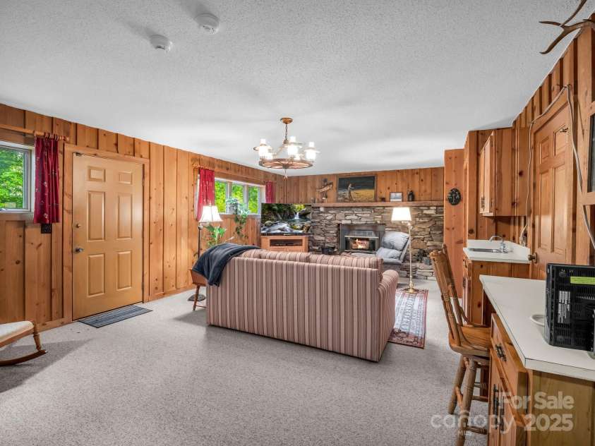 133 Pennwood Lane, Flat Rock, NC 28731.  MLS# CAR4268654, YatesRealty ID 19101. Lower level family room with access to back yard.