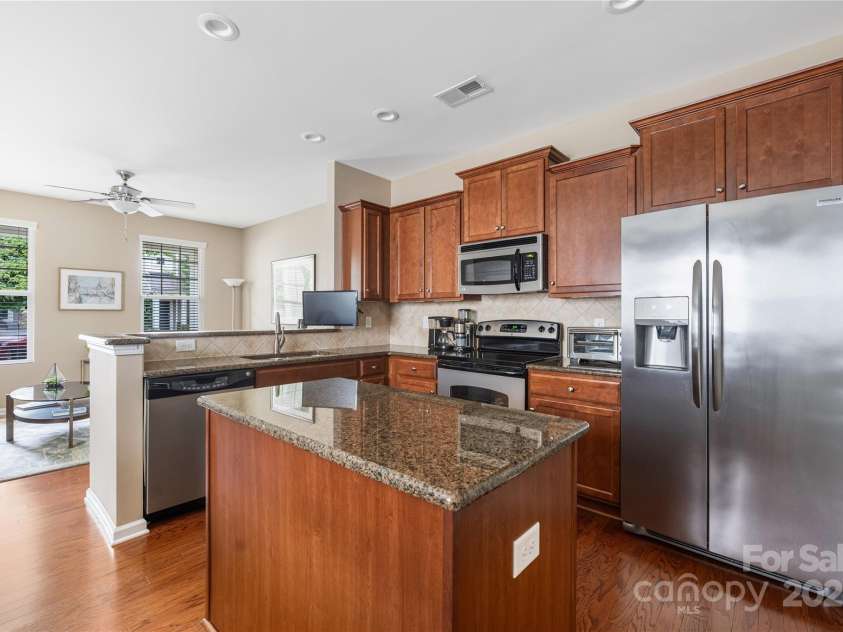 13107 Heath Grove Drive, Huntersville, NC 28078.  MLS# CAR4259470, YatesRealty ID 19108. Kitchen with island and granite counter tops.