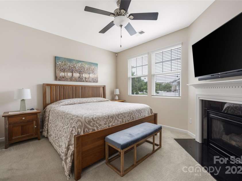 13107 Heath Grove Drive, Huntersville, NC 28078.  MLS# CAR4259470, YatesRealty ID 19108. Primary bedroom has a gas log fireplace.