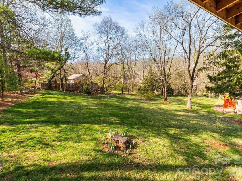 121 Churchill Downs Drive, Fairview, NC 28730.  MLS# CAR4366087, YatesRealty ID 19111. Backyard Tree Line
