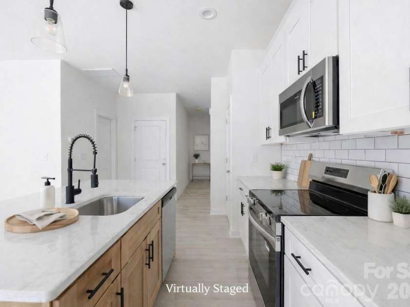 659 Stillgreen Lane, Charlotte, NC 28214.  MLS# CAR4356010, YatesRealty ID 19119. Kitchen with Level 3 Quartz Countertops and Stainless Appliances! Virtually Staged Photo