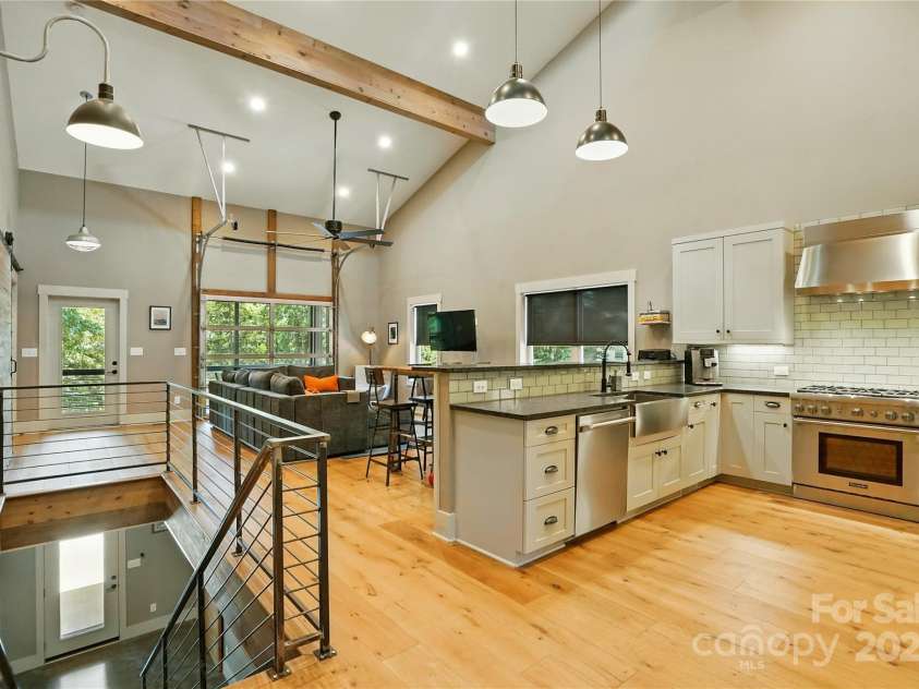 16525 Tulloch Road, Charlotte, NC 28278.  MLS# CAR4267483, YatesRealty ID 19120. Crafted for effortless entertaining, the open-concept layout centers around a chef’s dream kitchen, complete with high-end appliances and seamless flow into the dramatic great room with floor-to-ceiling windows