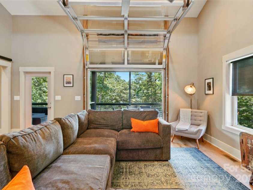 16525 Tulloch Road, Charlotte, NC 28278.  MLS# CAR4267483, YatesRealty ID 19120. Here, the magnificent floor-to-ceiling windows create a stunning backdrop, and direct access to the covered screened porch with durable Trex decking extends your living space outdoors