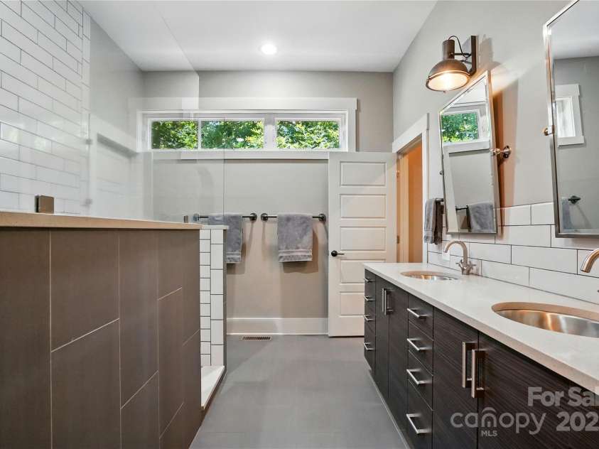 16525 Tulloch Road, Charlotte, NC 28278.  MLS# CAR4267483, YatesRealty ID 19120. Primary bath features dual sinks, walk-in shower, and huge walk-in closet with built-in cabinetry