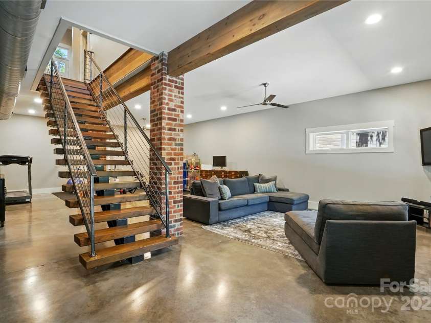 16525 Tulloch Road, Charlotte, NC 28278.  MLS# CAR4267483, YatesRealty ID 19120. The expansive walk-out basement provides an incredible retreat for you and your guests, featuring a comfortable secondary bedroom, a full bath, a versatile rec room, and a flexible room perfect for a home gym, office, o