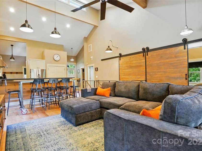 16525 Tulloch Road, Charlotte, NC 28278.  MLS# CAR4267483, YatesRealty ID 19120. This custom-built industrial-style home features a bold design, high-end finishes, exposed wood beams, metal ductwork, stainless railings, floating staircase, and large windows to maximize natural light and unforgettabl