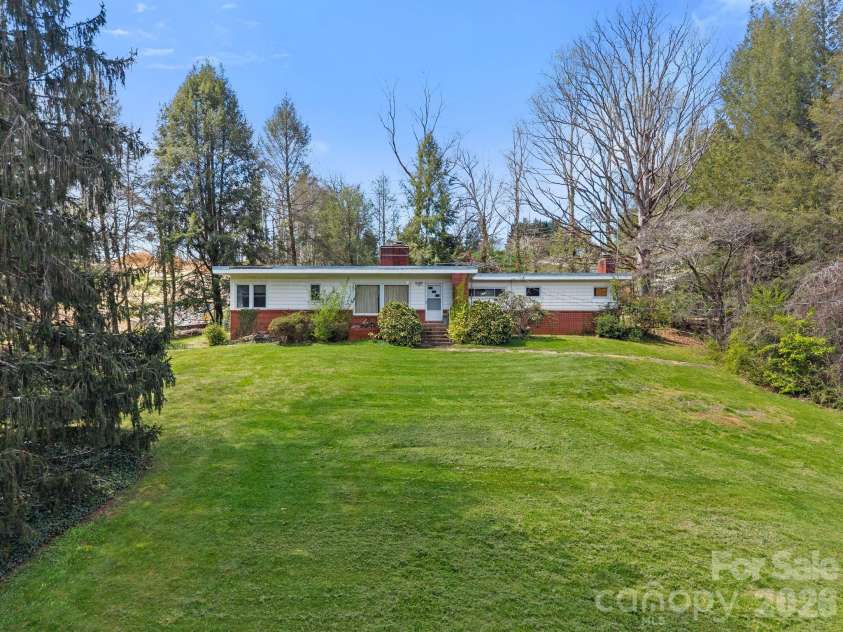 7 Acton Woods Road, Candler, NC 28715.  MLS# CAR4362191, YatesRealty ID 19120. Gently sloping lot.