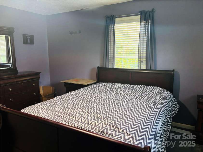 16 English Oaks Drive, Candler, NC 28715.  MLS# CAR4258090, YatesRealty ID 19142. Primary bedroom