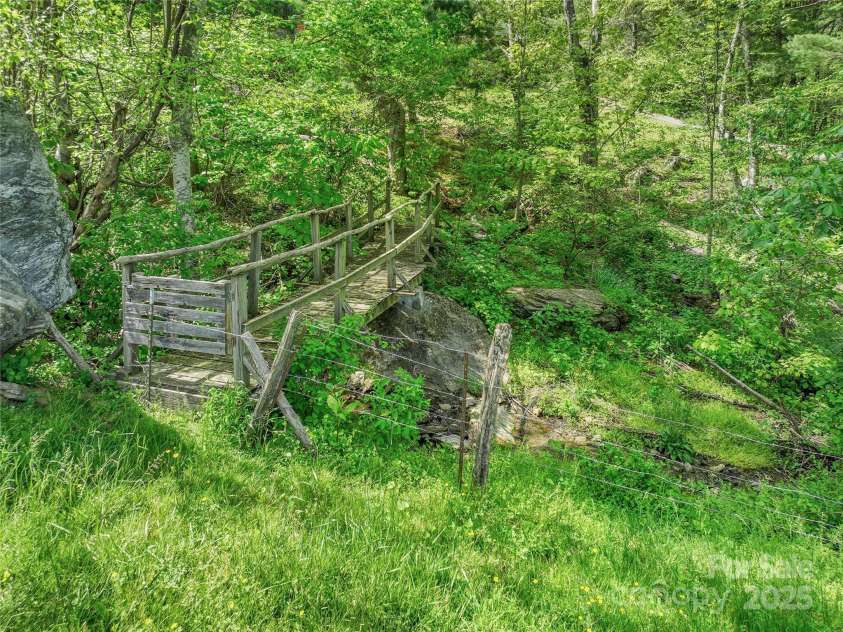 315 Morgan Branch Road, Leicester, NC 28748.  MLS# CAR4252510, YatesRealty ID 19145. Bridge across creek