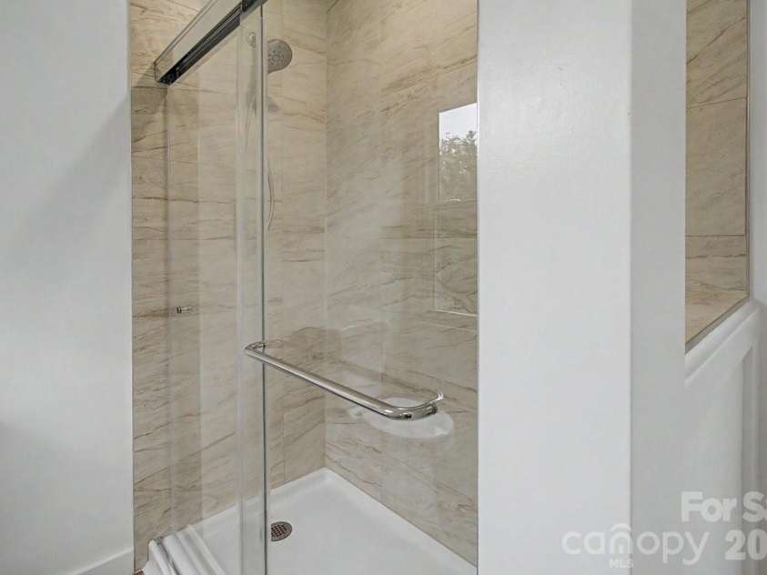 40 Evelake Drive, Asheville, NC 28806.  MLS# CAR4353520, YatesRealty ID 19151. Easy access shower in Primary Bathroom. Newly added glass doors