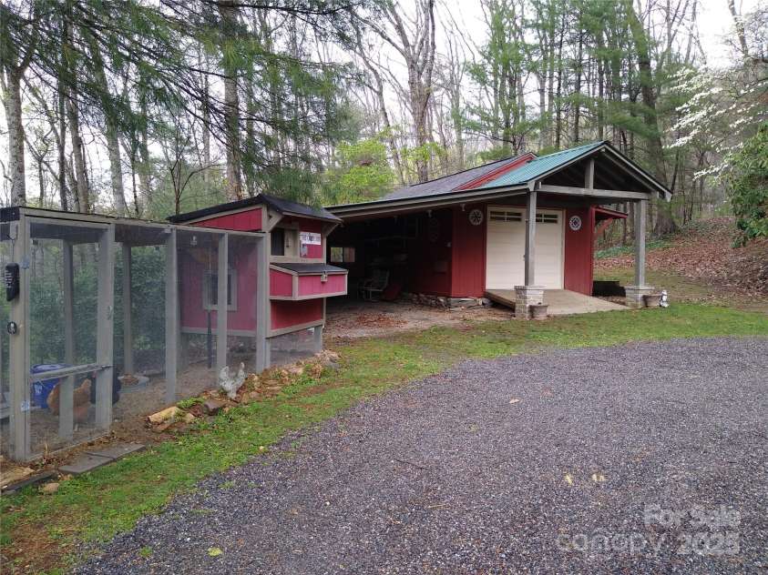 242 Birch Lane, Arden, NC 28704.  MLS# CAR4249293, YatesRealty ID 19164. A 14'x24' outbuilding with electricity and an attached carport plus a fully functional chicken coop!