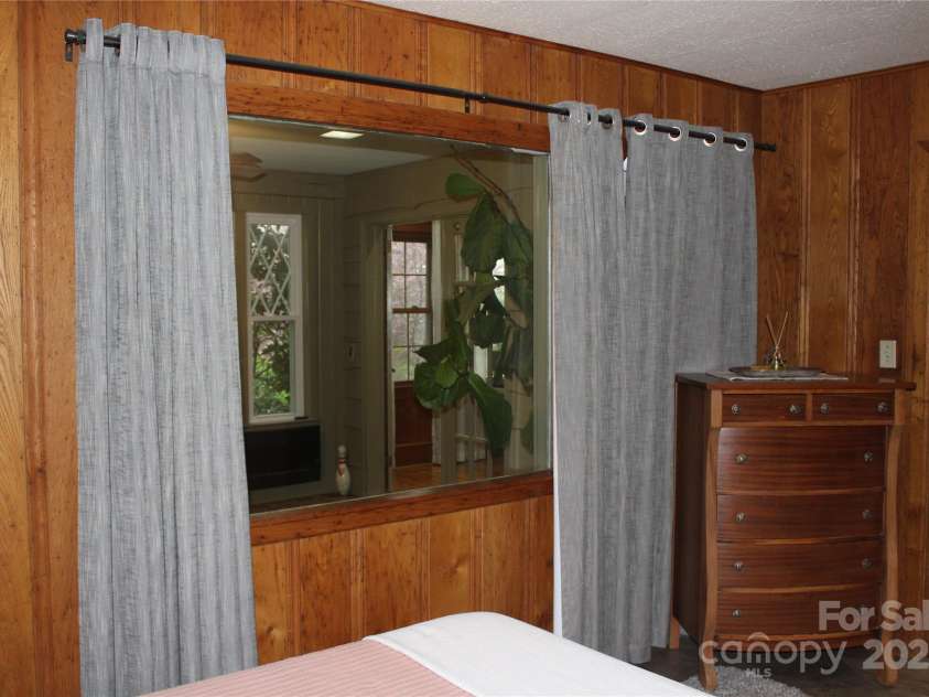 242 Birch Lane, Arden, NC 28704.  MLS# CAR4249293, YatesRealty ID 19164. Bedroom #3 also has lovely, wormy chestnut walls and a window looking into the backyard giving it a very cozy feeling. There is also a window looking into the sunroom/office plus a door there for ease of access.  This room as l
