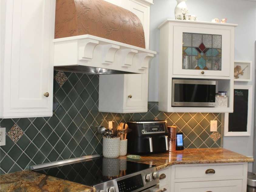 242 Birch Lane, Arden, NC 28704.  MLS# CAR4249293, YatesRealty ID 19164. Custom, curved range hood, stained glass accent door, and LG microwave