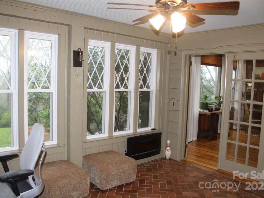 242 Birch Lane, Arden, NC 28704.  MLS# CAR4249293, YatesRealty ID 19164. Lovely Sunroom/Office with abundant windows and beautiful ceramic tile floors.