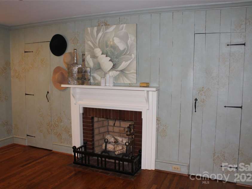 242 Birch Lane, Arden, NC 28704.  MLS# CAR4249293, YatesRealty ID 19164. Lovely wood-burning fireplace with closets on both sides.