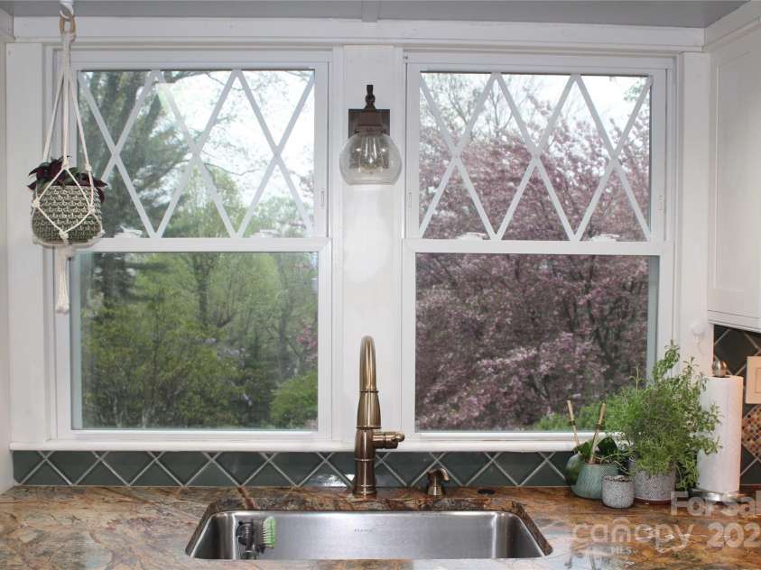 242 Birch Lane, Arden, NC 28704.  MLS# CAR4249293, YatesRealty ID 19164. Views of the beautiful landscaping and mountains from the kitchen windows