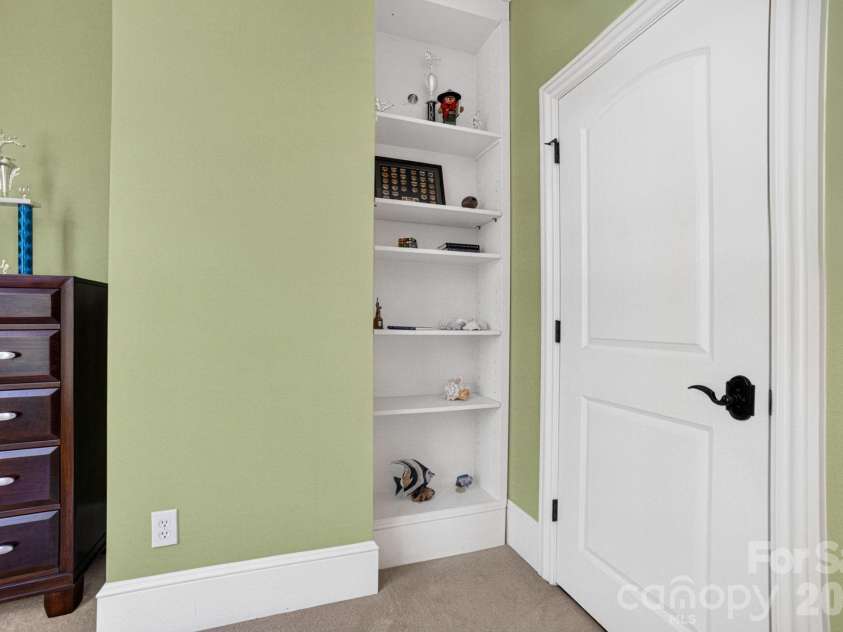 14705 Henry Harrison Stillwell Drive, Huntersville, NC 28078.  MLS# CAR4357146, YatesRealty ID 19182. Sliding bookcase!
