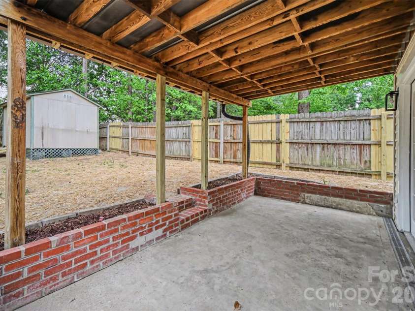 694 Forest Street, Concord, NC 28025.  MLS# CAR4367957, YatesRealty ID 19184. Backyard covered area