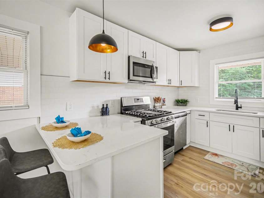 694 Forest Street, Concord, NC 28025.  MLS# CAR4367957, YatesRealty ID 19184. Kitchen with breakfast bar