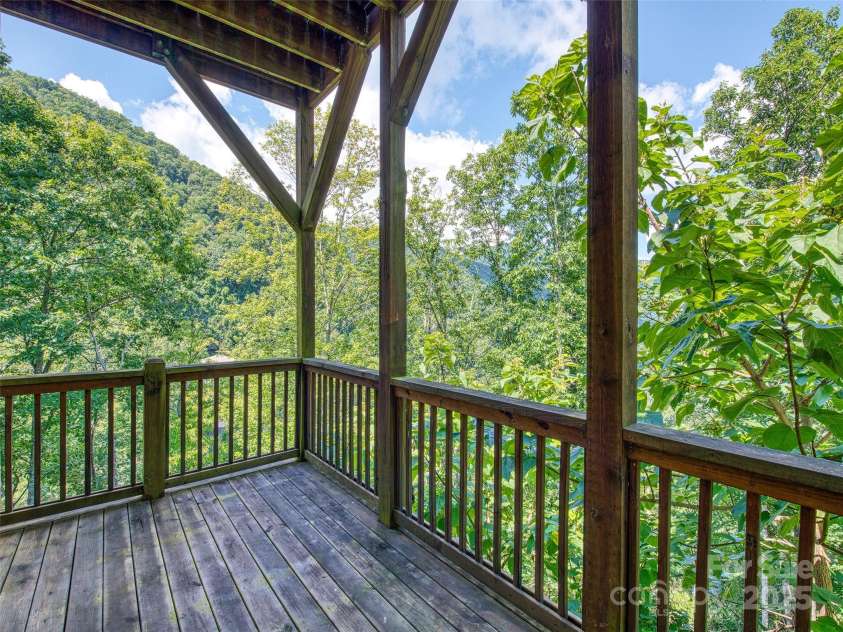 20A Lila Lane, Clyde, NC 28721.  MLS# CAR4258069, YatesRealty ID 19186. Covered deck off main level bedroom