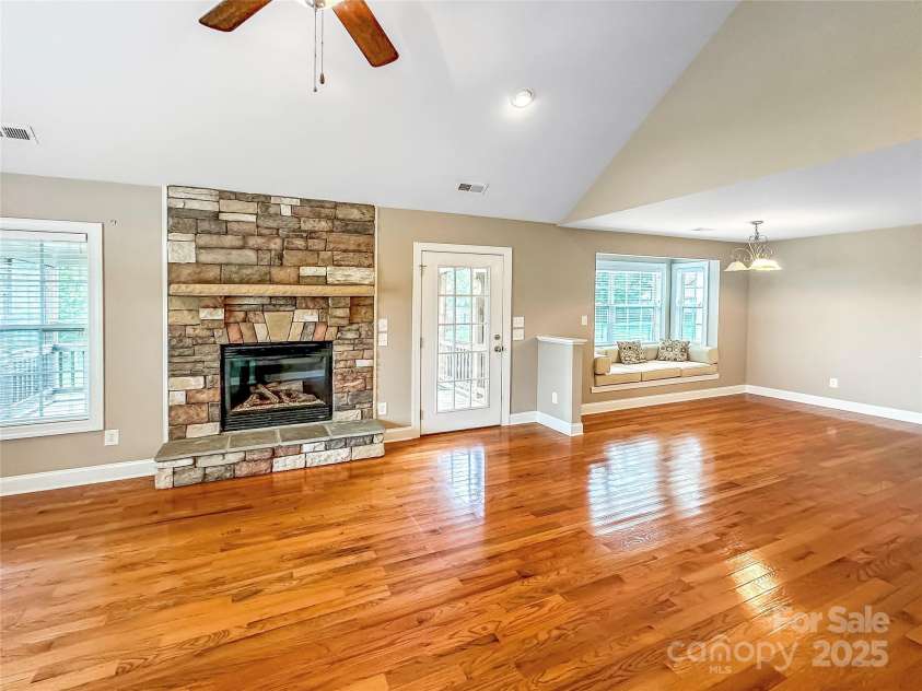 1625 Damascus Circle, Conover, NC 28613.  MLS# CAR4268019, YatesRealty ID 19188. Living room looking toward fireplace, door to deck and breakfast area