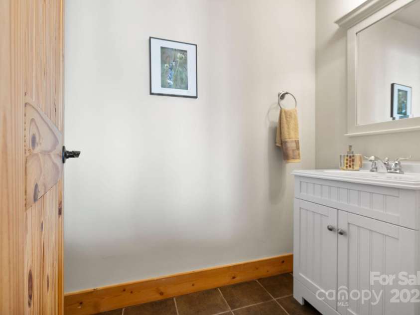 277 Kestrel Court, Sapphire, NC 28774.  MLS# CAR4238900, YatesRealty ID 19199. Lower level half bath.