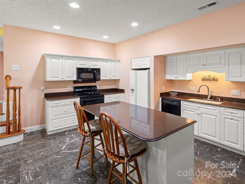 4901 Brevard Road, Horse Shoe, NC 28742.  MLS# CAR4180919, YatesRealty ID 192. Main house basement kitchen