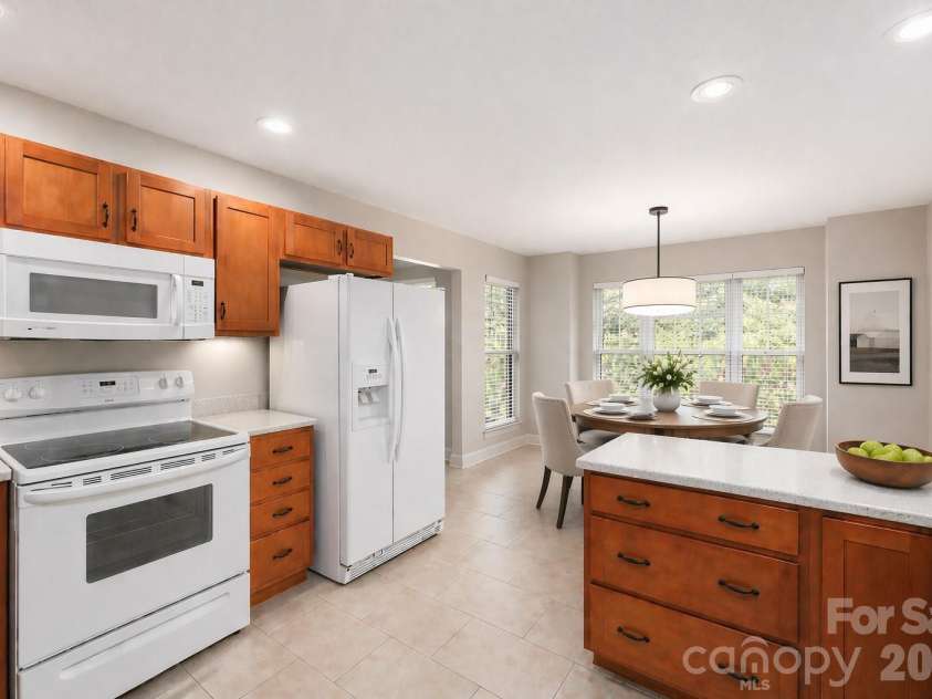 8 Kaylor Drive, Arden, NC 28704.  MLS# CAR4369533, YatesRealty ID 19216. Kitchen with dining area virtually staged.