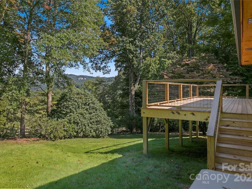 181 Pleasant Hill Drive, Brevard, NC 28712.  MLS# CAR4247052, YatesRealty ID 19238. Backyard With Mature Trees And Blueberry Bushes