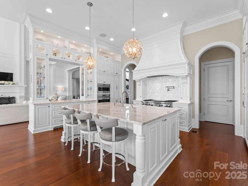 8228 Bay Pointe Drive, Denver, NC 28037.  MLS# CAR4238879, YatesRealty ID 19243. Gourmet, Chef's Kitchen with every convenience & amazing features including Quartzite counters, marble back splash, sub-zero refrigerator, coffee bar, built in beverage refrigerator with ice maker, Wolf Gas Range with c