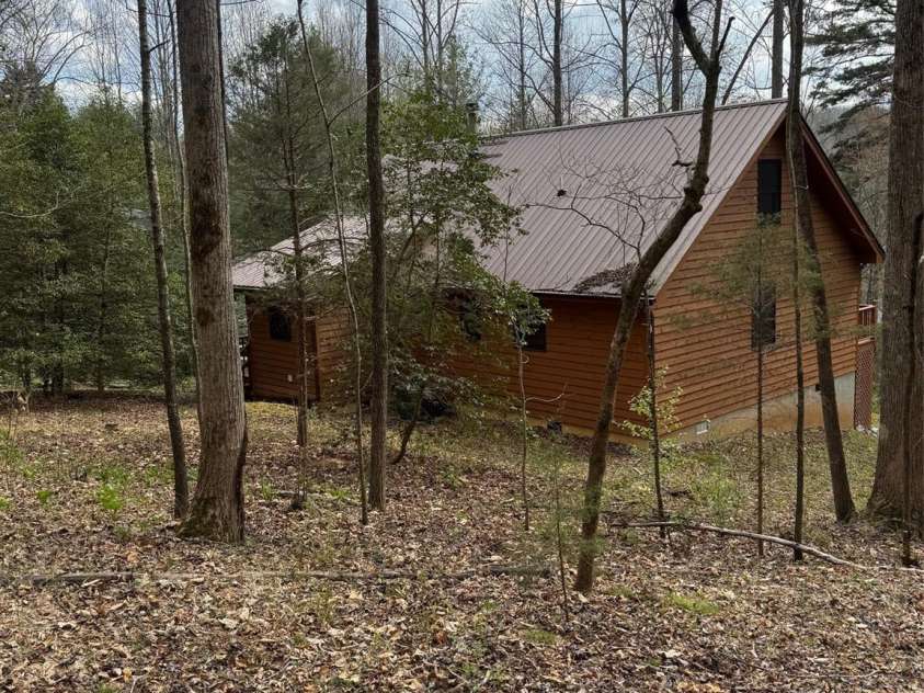 315 River Road, Sylva, NC 28779.  MLS# CAR4365027, YatesRealty ID 19267. Back yard's gentle slope.