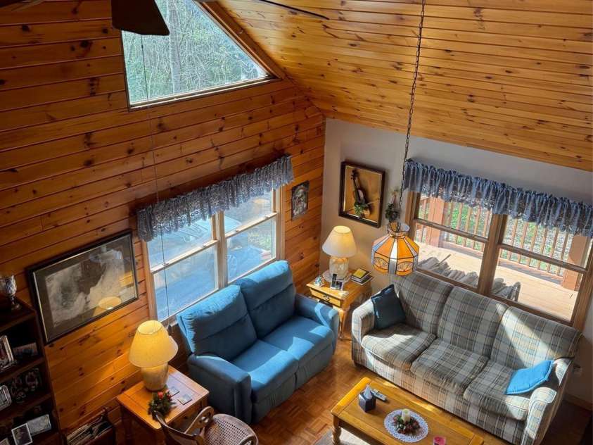 315 River Road, Sylva, NC 28779.  MLS# CAR4365027, YatesRealty ID 19267. Cathedral ceiling and open den and dining area.