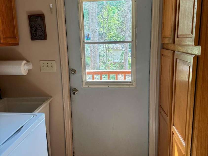 315 River Road, Sylva, NC 28779.  MLS# CAR4365027, YatesRealty ID 19267. Easy access to the covered back porch which owners use as access and laundry room/pantry.  Could easily be converted to additional kitchen space.