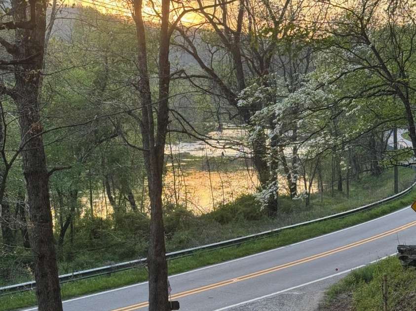 315 River Road, Sylva, NC 28779.  MLS# CAR4365027, YatesRealty ID 19267. Sunset reflected on the river--every day views from this property