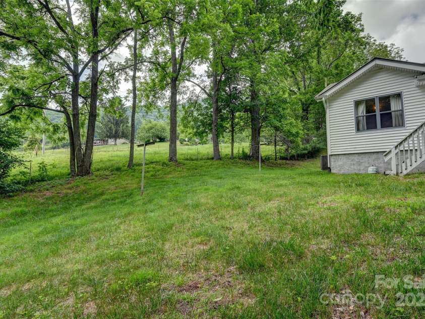 121 Walnut Holler Drive, Waynesville, NC 28786.  MLS# CAR4267456, YatesRealty ID 19273. Back yard gently sloping