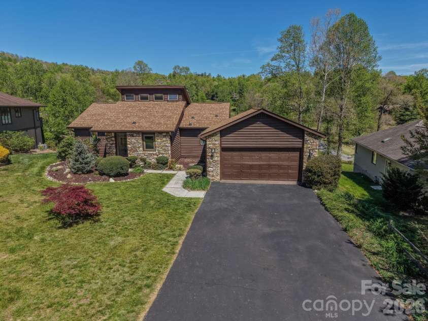 3104 Cove Loop Road, Hendersonville, NC 28739.  MLS# CAR4362842, YatesRealty ID 19289. Front aerial view showcasing the home’s setting, layout, and surrounding landscape.