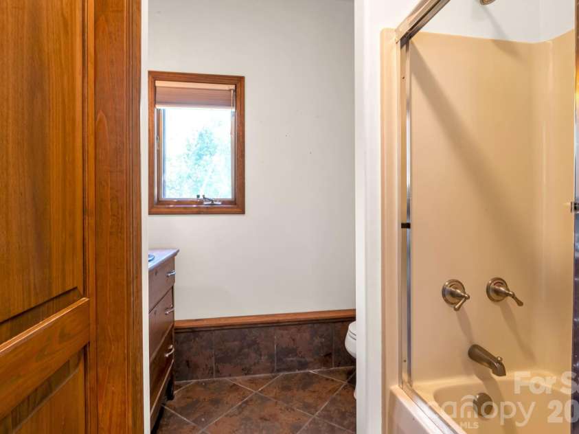3104 Cove Loop Road, Hendersonville, NC 28739.  MLS# CAR4362842, YatesRealty ID 19289. Third full bathroom serving the lower level