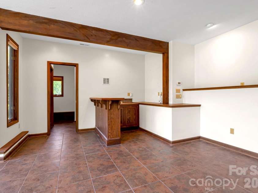 3104 Cove Loop Road, Hendersonville, NC 28739.  MLS# CAR4362842, YatesRealty ID 19289. Versatile lower-level rec space for multiple uses