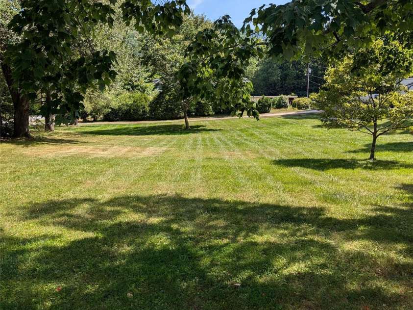 3106 Brevard Road, Hendersonville, NC 28791.  MLS# CAR4154139, YatesRealty ID 19297. Side lawn