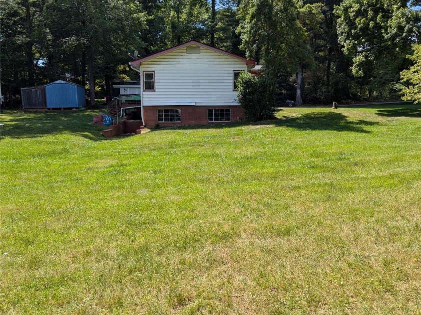 3106 Brevard Road, Hendersonville, NC 28791.  MLS# CAR4154139, YatesRealty ID 19297. Side lawn